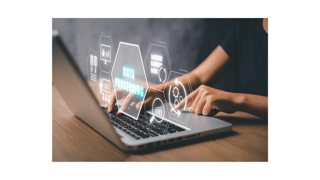 A technology professional working with data analytics on a laptop